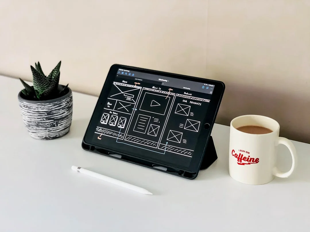 Stylish and efficient workspace with multiple monitors, laptop, and smartphone, showcasing a web design project.